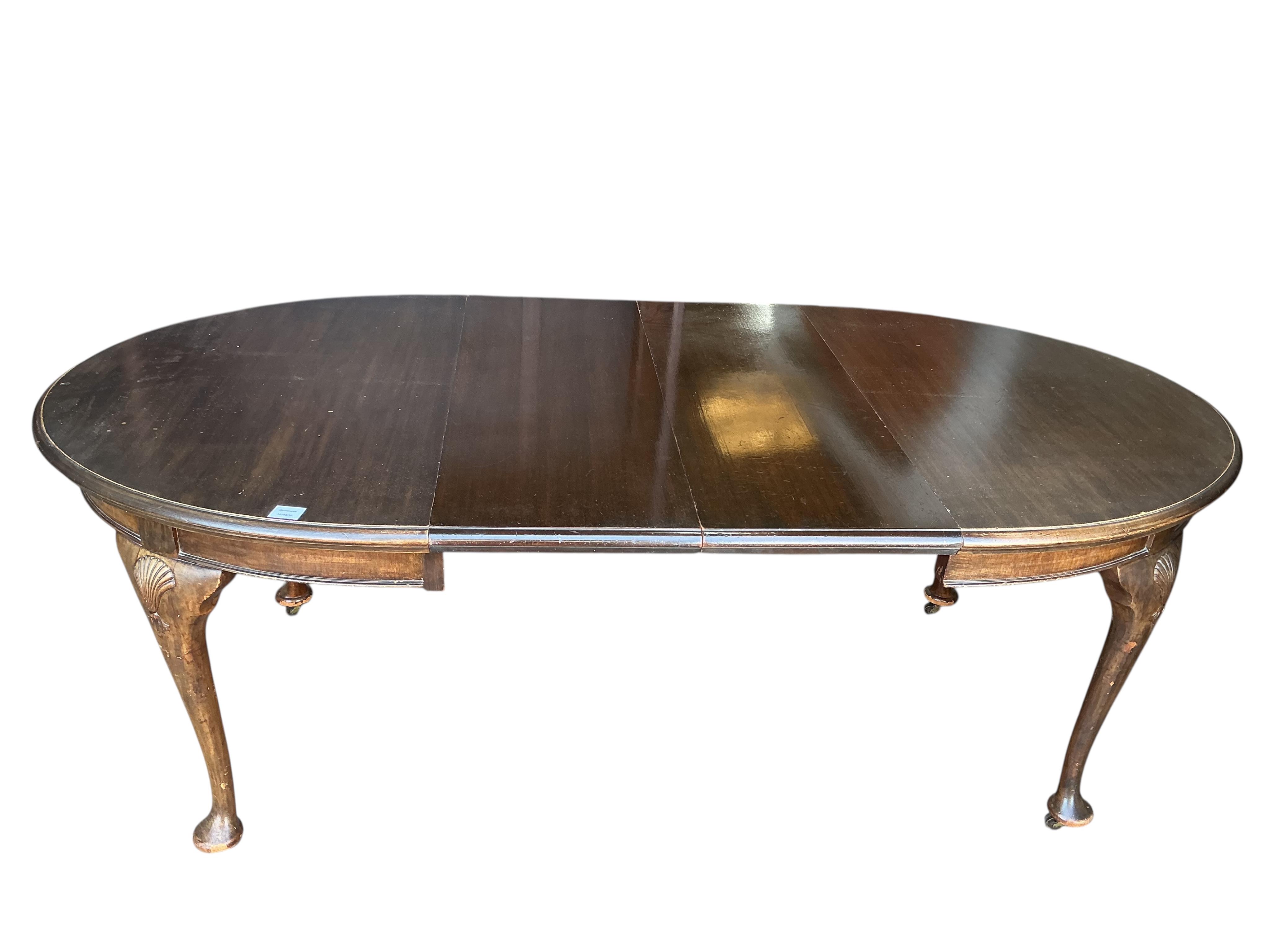 A Chippendale Revival mahogany extending dining table, 210cm extended, two spare leaves, depth 106cm, height 74cm together with a set of six Chippendale Revival mahogany dining chairs, two with arms